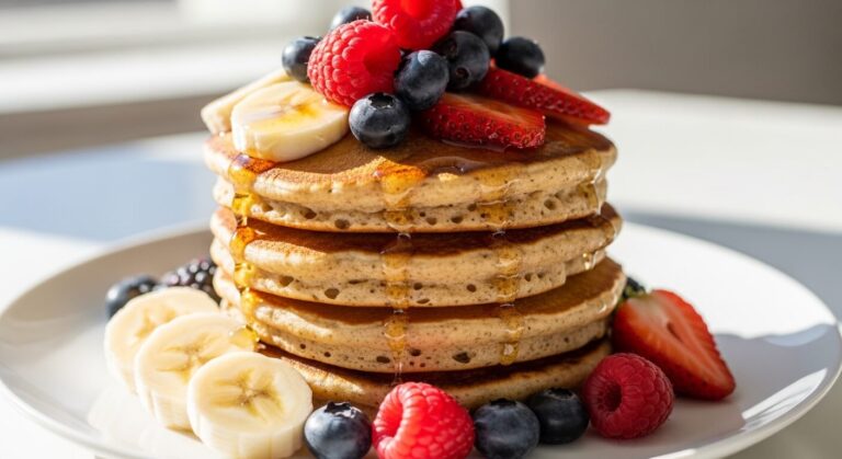 Pancake protéine empilé avec fruits rouges et rondelles de banane.